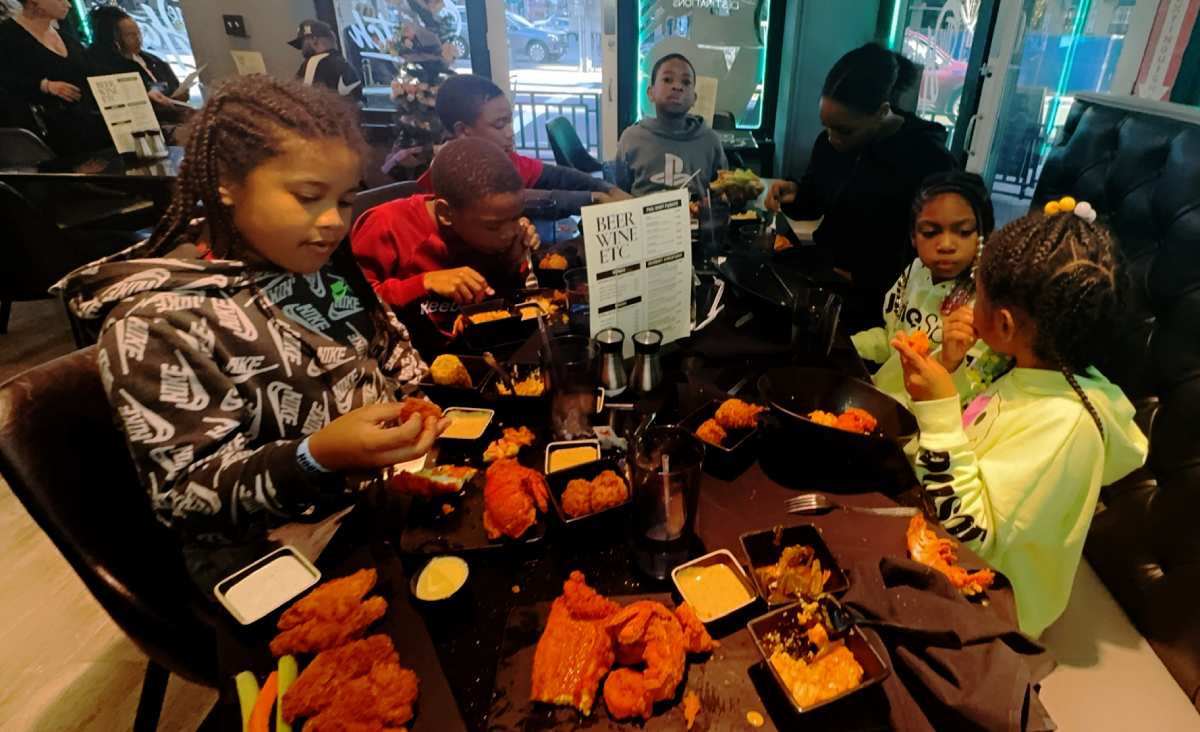 A family enjoying southern food at The Hatch